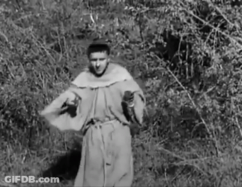 Man In Robe Standing In Field With Trees GIF
