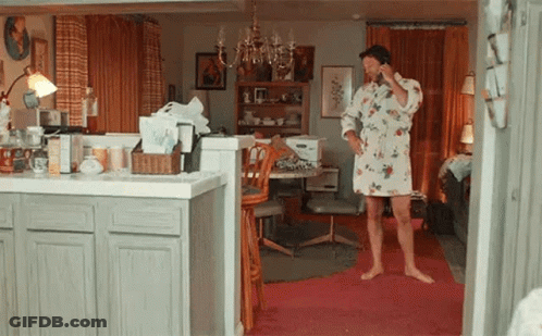 Man In Robe Talking On Cell Phone In Kitchen GIF