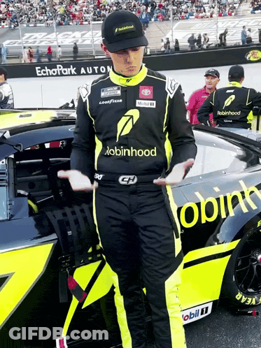 Man In Robin Hood Shirt Beside Race Car GIF