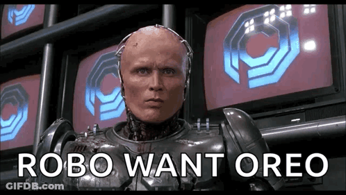 Man In Robot Suit Standing In Front Of Factory GIF