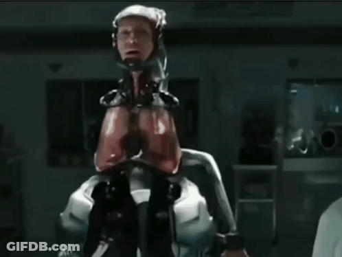 Man In Robotic Suit Near Emergency Exit Sign GIF