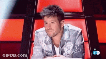 Man In Rock-Embroidered Denim Jacket Red Chair GIF