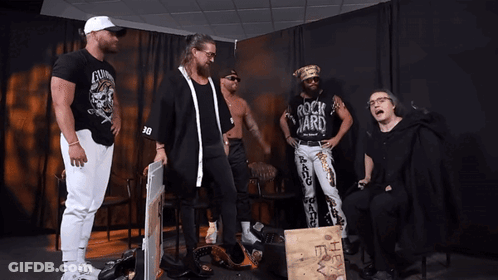Man In Rock Yard Shirt With Other Men GIF