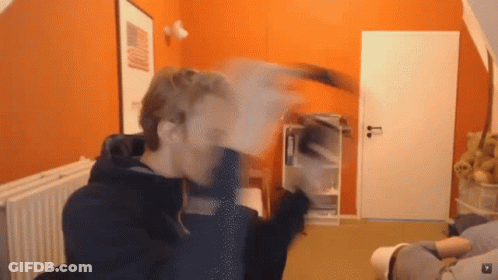 Man In Room With Orange Wall And White Door GIF