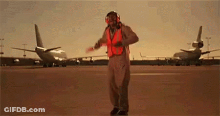 Man In Safety Vest Holding Red Baton GIF