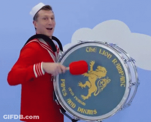 Man In Sailor Costume Playing Drum Saying Pipes And Drums GIF
