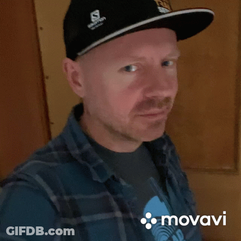 Man In Salomon Hat Plaid Shirt Smiles GIF