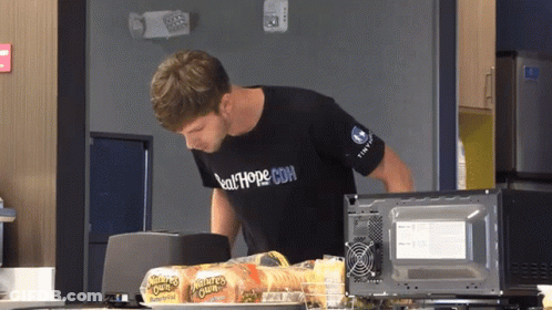 Man In Salthope.com Shirt Reaches Into Microwave GIF