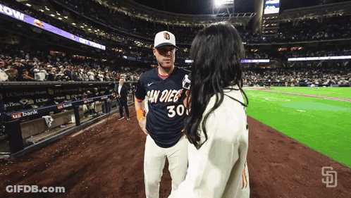 Man In San Diego Jersey Talking To Woman GIF