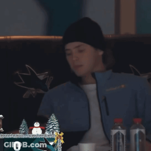 Man In San Jose Sharks Jacket Looking At Phone GIF