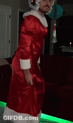 Man In Santa Costume Dancing In Front Of Couch GIF
