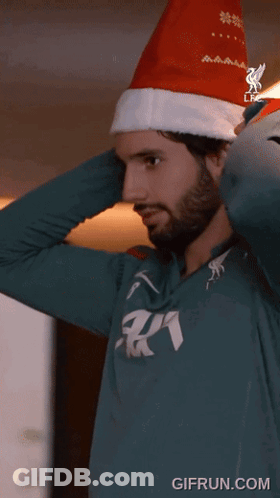 Man In Santa Hat And Green AA Shirt GIF