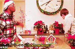 Man In Santa Hat Talking To Man GIF
