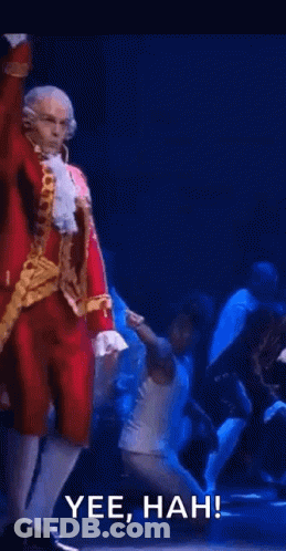 Man In Santa Suit Dancing On Stage GIF