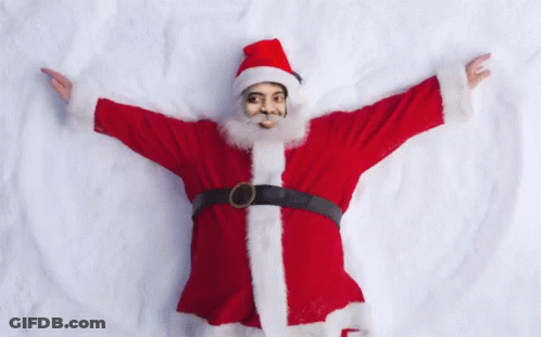 Man In Santa Suit Laying In Snow With Arms Outstretched GIF