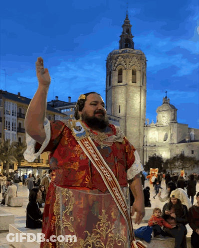 Man In Sash Saying Espana In Front Of Building GIF