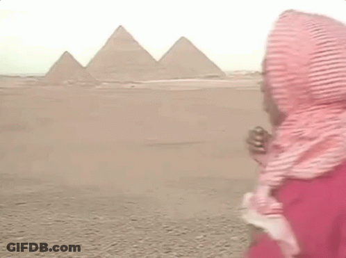 Man In Scarf And Red Shirt At Pyramids GIF