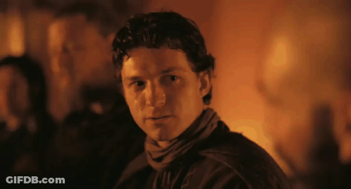 Man In Scarf Looking At Camera Dark Room GIF