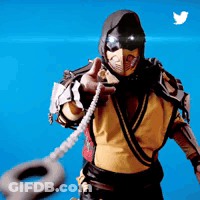 Man In Scorpion Costume Holding Tire Pointing At Camera GIF