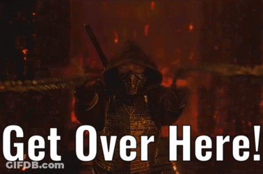 Man In Scorpion Costume Holding Tire Pointing GIF