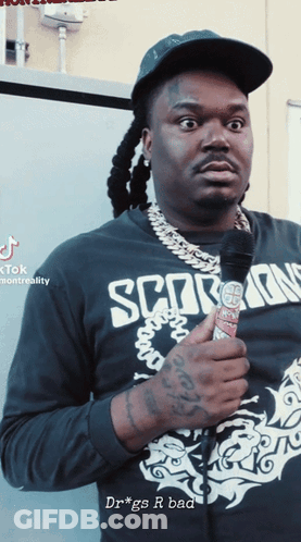 Man In Scorpions Shirt Holding Microphone GIF