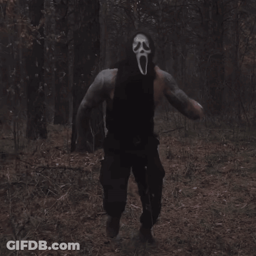 Man In Scream Mask Walking Through Woods GIF