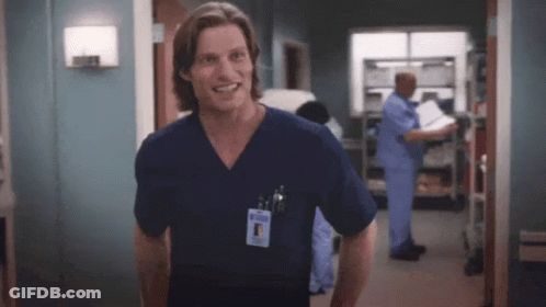 Man In Scrub Top Smiling In Hospital Room GIF