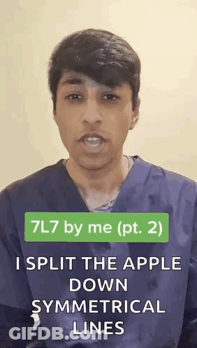 Man In Scrub Top Splitting Apple Along Symmetrical Lines GIF