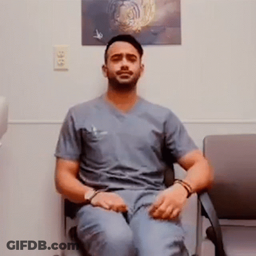 Man In Scrubs Cross-Legged Next To Tiger Picture GIF