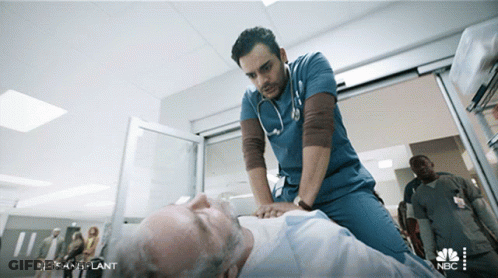 Man In Scrubs Gives Heartbeat To Older Man In ER GIF