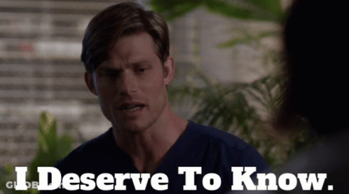 Man In Scrubs Saying I Deserve To Know In Front Of Plant GIF