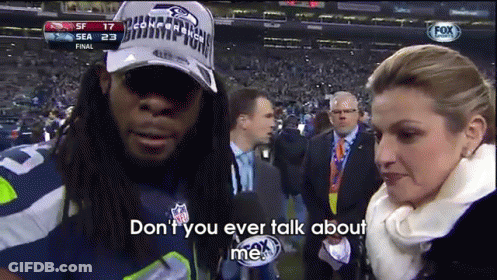 Man In Seahawks Hat Talking To Reporter GIF