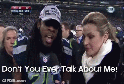 Man In Seahawks Hat With Woman Saying Don't You Ever Talk About Me GIF