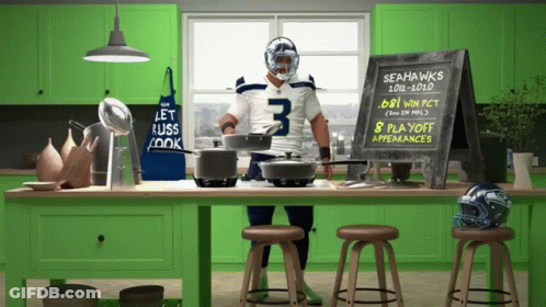 Man In Seahawks Jersey In Front Of Chalkboard Saying 8 Playoff Appearances GIF