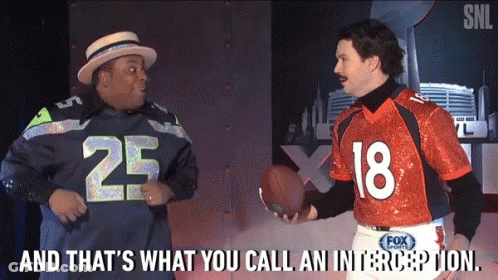 Man In Seahawks Jersey Talking To Man In Orange Jersey Number 18 GIF