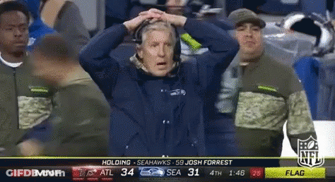 Man In Seahawks Shirt Holding Head GIF