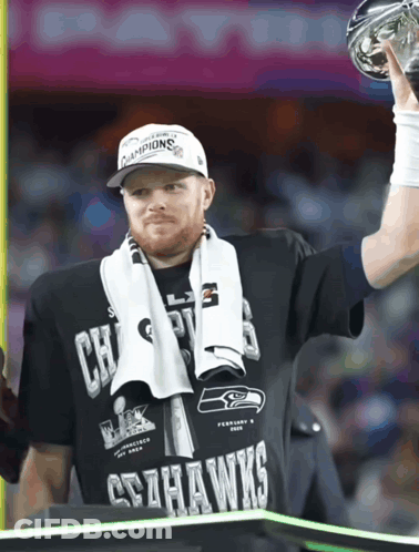 Man In Seahawks T-Shirt Holding Trophy GIF