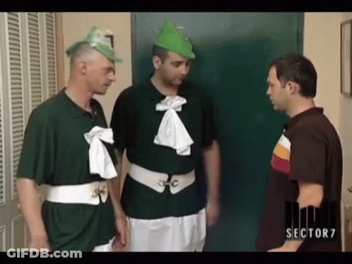 Man In Sector 7 Shirt Talks To Two Men In Green Shirts GIF