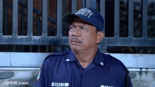 Man In Security Hat Standing In Front Of Fence GIF