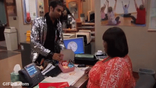 Man In Sequined Jacket Giving Woman Gift GIF