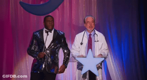 Man In Sequined Suit Next To Man In Lab Coat Holding Star GIF