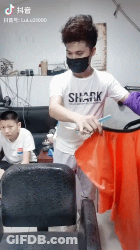 Man In Shark Shirt Cutting Red Cloth GIF