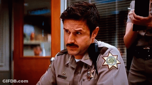 Man In Sheriff's Uniform With Mustache And Star GIF