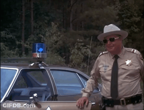 Man In Sheriff Uniform Leaning On Car GIF