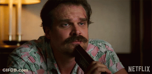 Man In Sheriff Uniform Next To Netflix Logo GIF