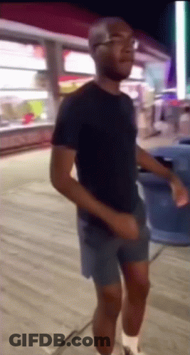 Man In Shorts And Black Shirt Dancing GIF