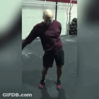 Man In Shorts And Red Sweater Dancing In Gym GIF