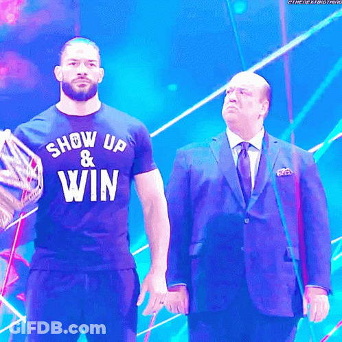 Man In Show Up And Win Shirt Next To Another Man GIF