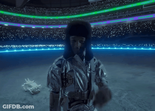 Man In Silver Jacket At Stadium With NFL Sign GIF