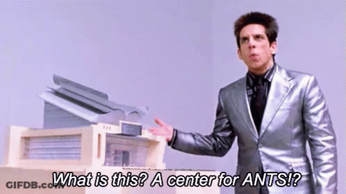 Man In Silver Suit Standing In Front Of Printer GIF